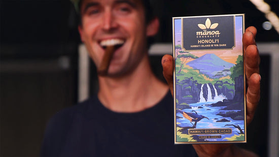 Image of cacao farmer holding a Honoli'i chocolate bar with colorful packaging