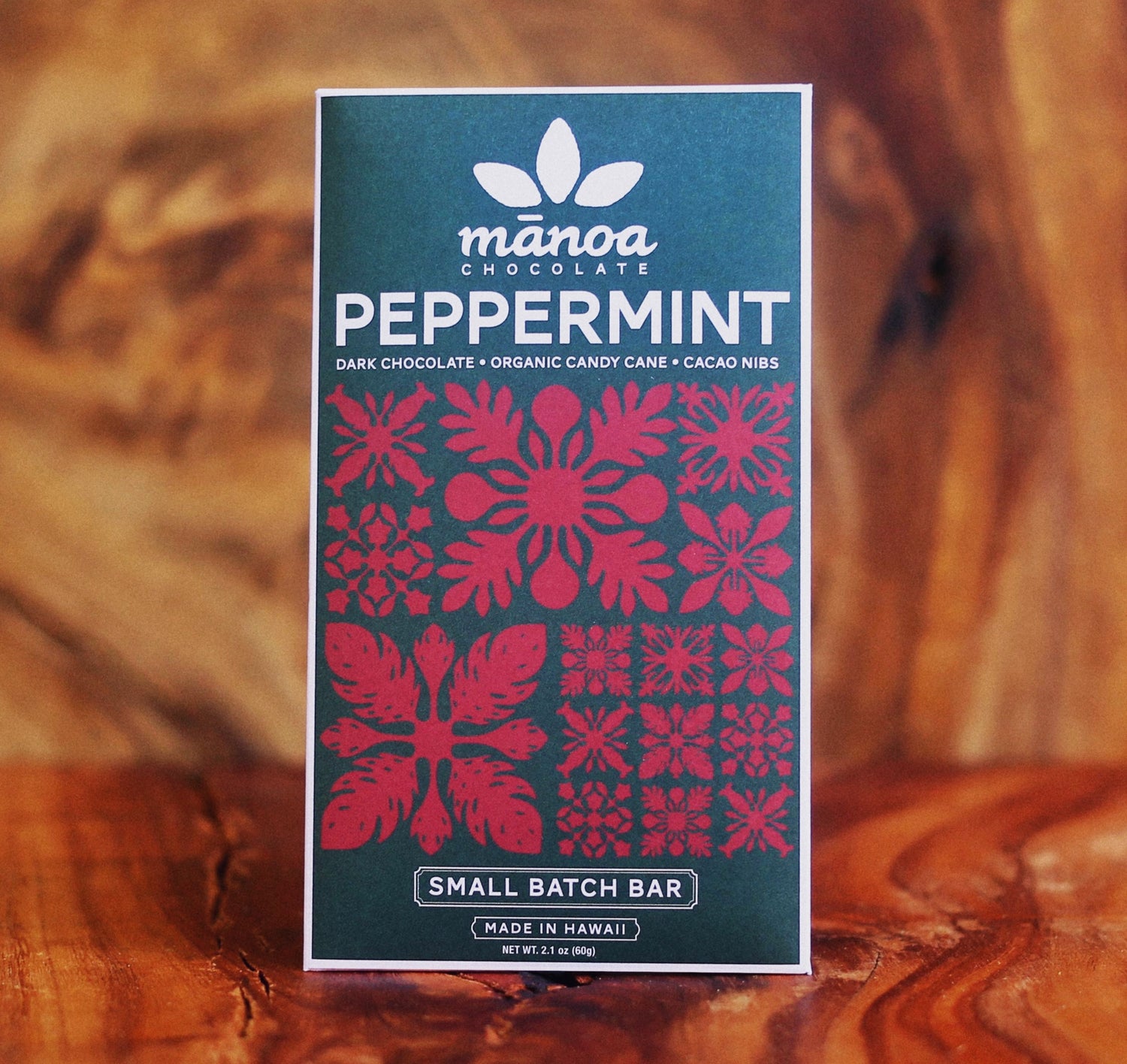 Image of peppermint bar in dark green package with red Hawaiian quilt pattern