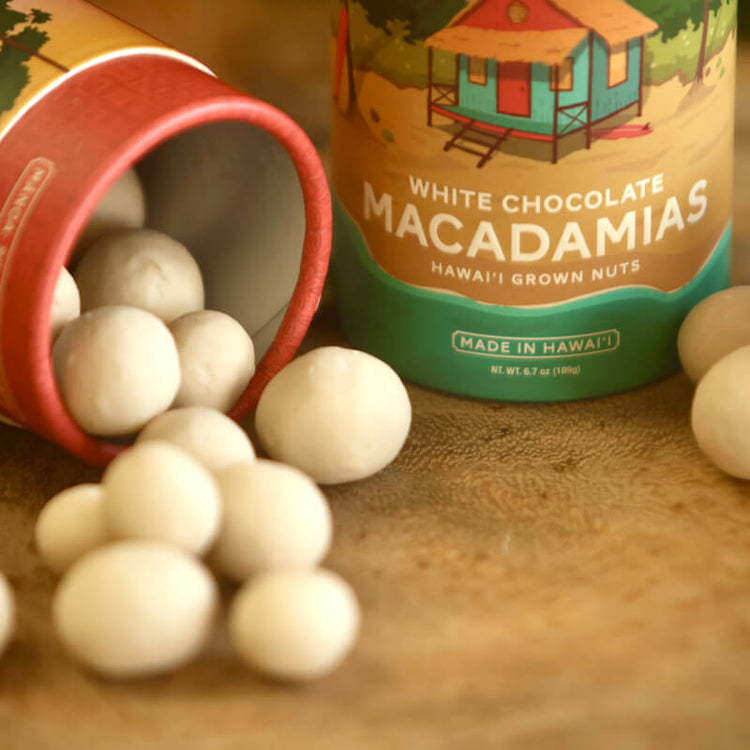 Close-up image of white chocolate macadamia nuts spilling out of their tube