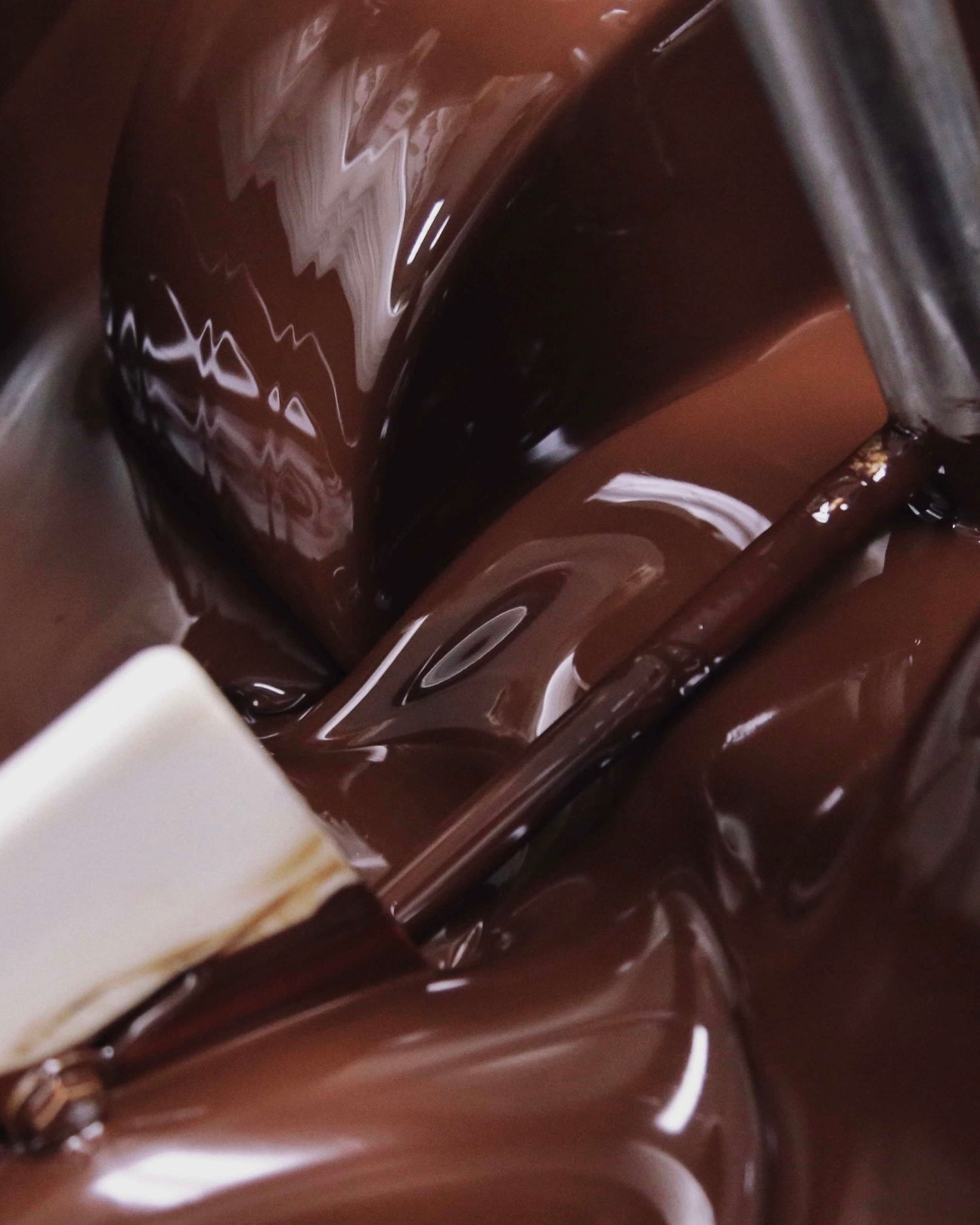 Image of liquid chocolate in industrial machine