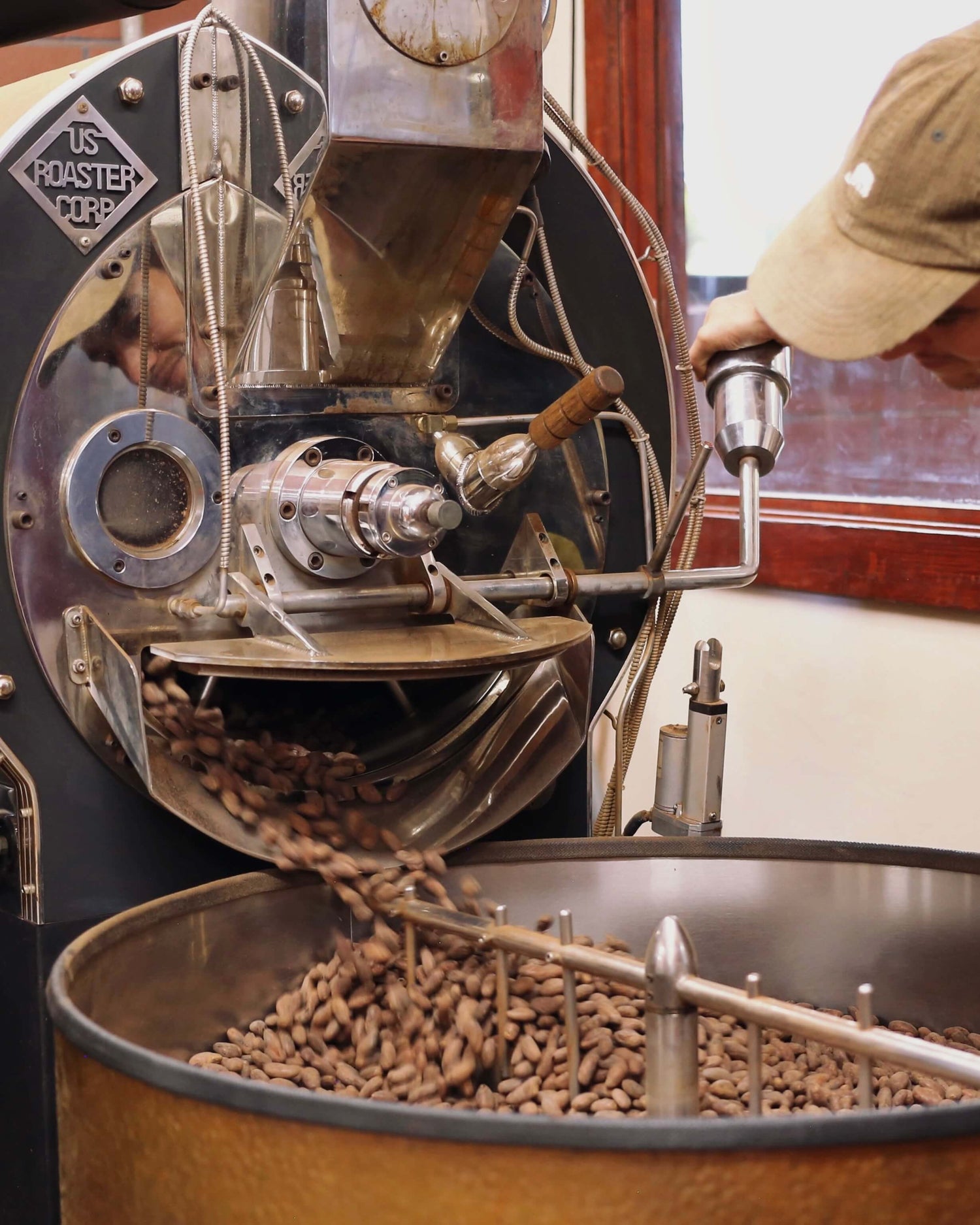 Image of cacao beans being roasted in industrial coffee roasting machine