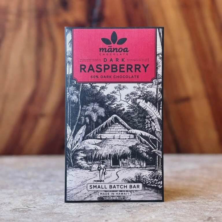 Manoa Chocolate Dark Raspberry chocolate bar packaging on a wooden surface