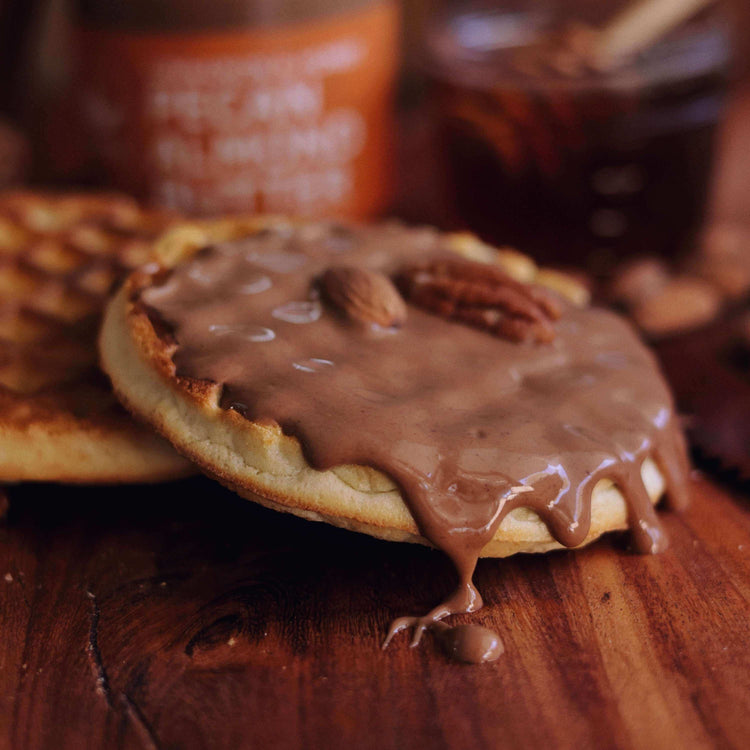 Pecan almond butter dripping off toasted waffle