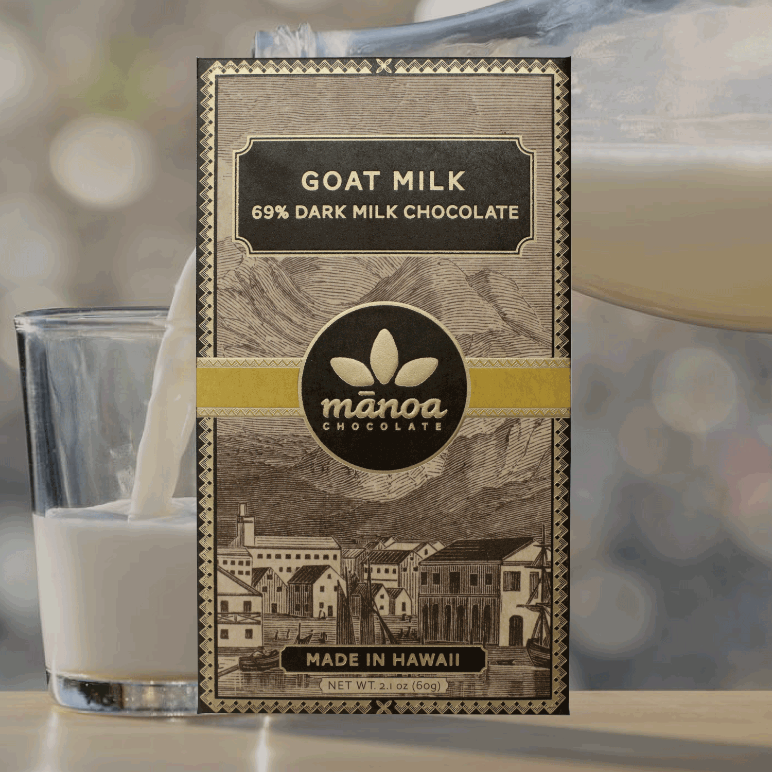 Image of Goat milk chocolate bar, in brown, natural-looking packaging, with a glass of milk