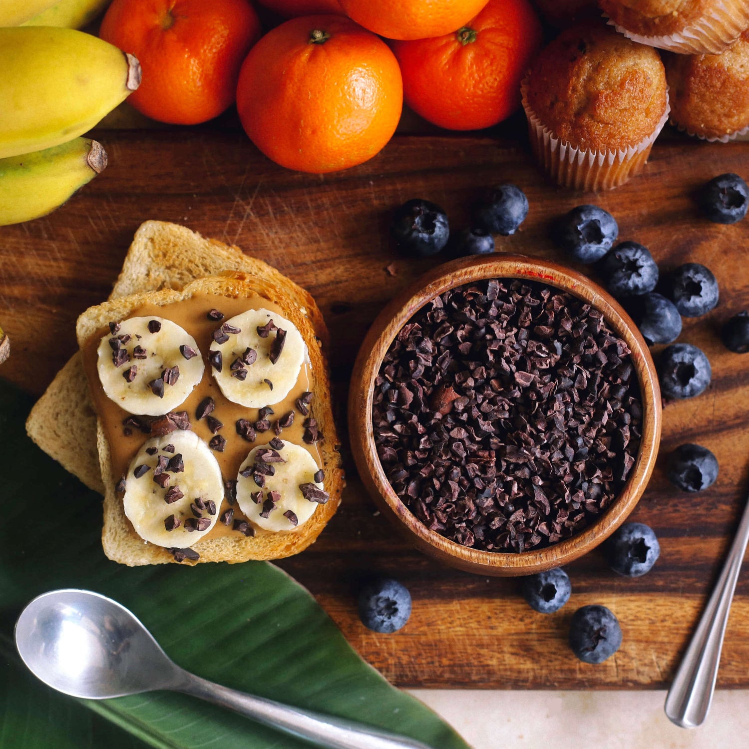 Image of toast with peanut butter, sliced banana and cacao nibs