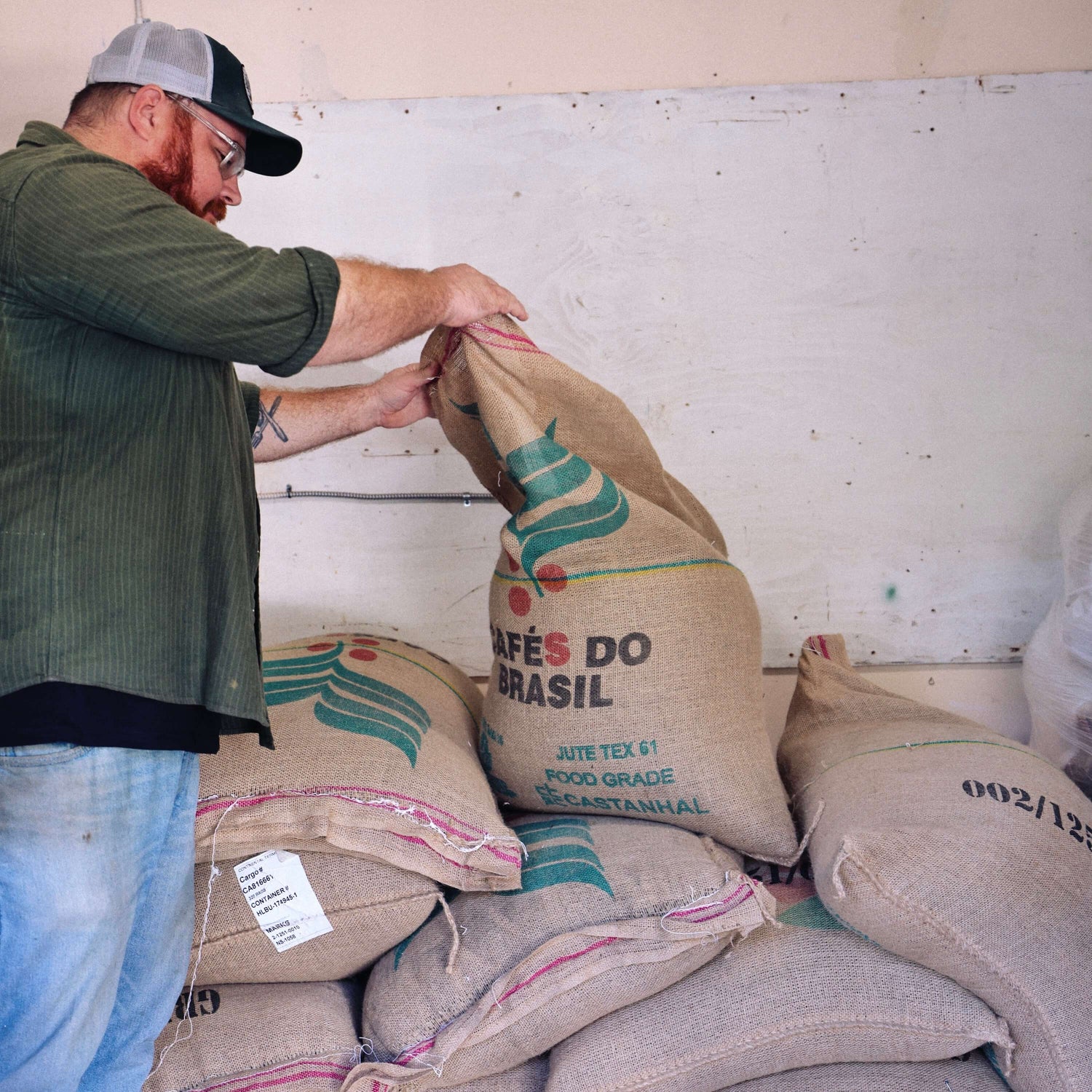 image of man opening coffee bag
