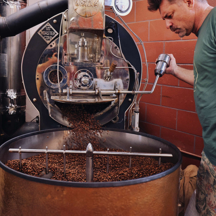 image of man opening coffee roaster