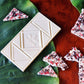 image of peppermint crunch white chocolate bar on a table with broken pieces of the same bar around it