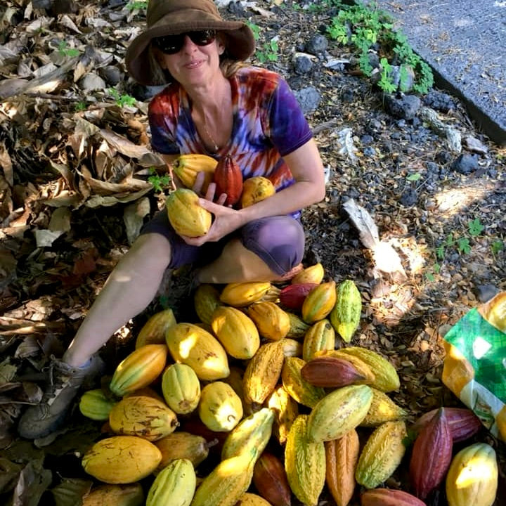 Image of woman posing with cacao pods