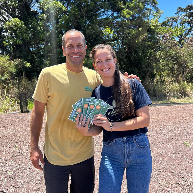 image of two happy people holding Kokua Farms chocolate bars