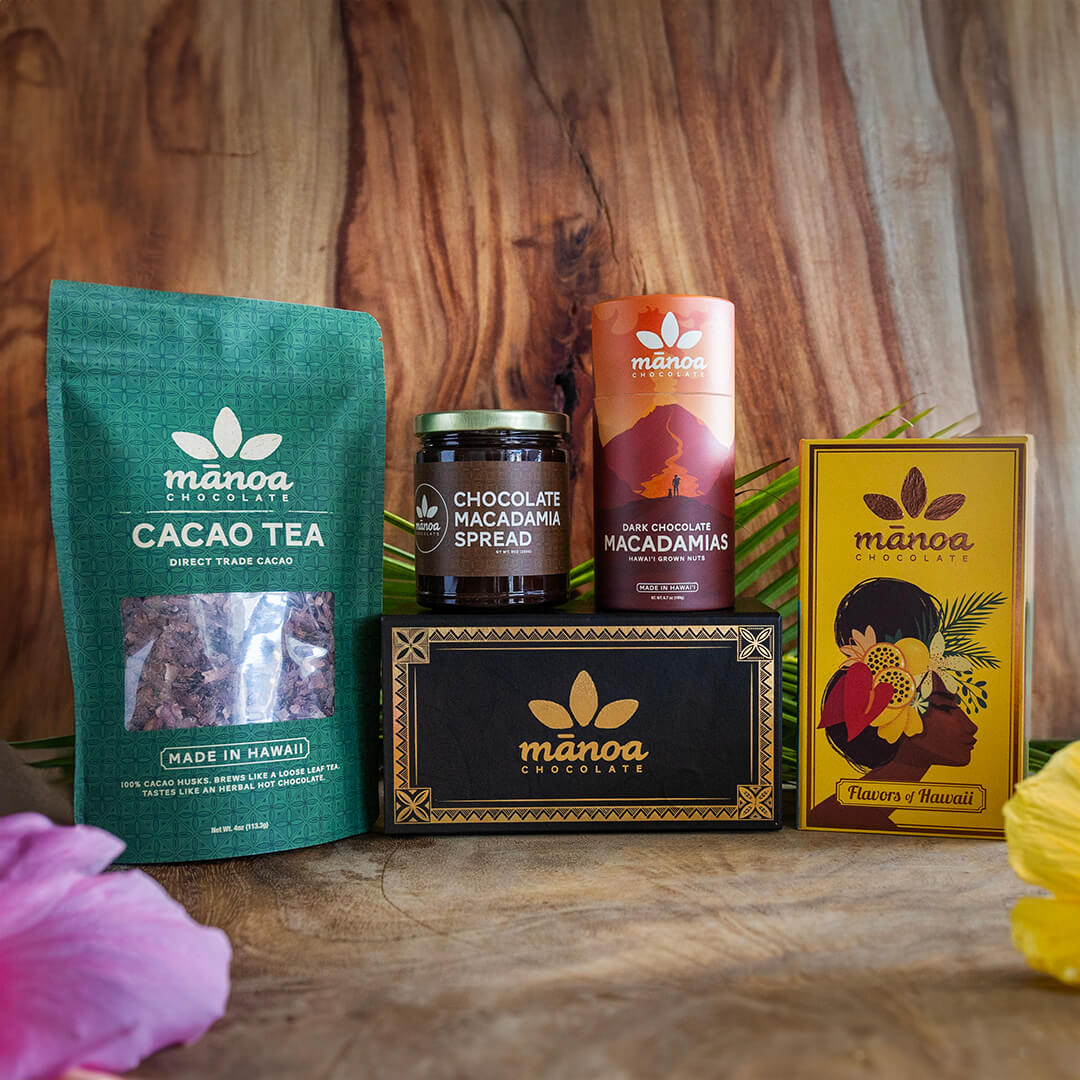 Image of 8oz pouch of cacao tea, tube of dark chocolate macadamias, jar of chocolate macadamia nut spread, Flavors of Hawaii chocolate gift box, and Hawaii grown chocolate gift box