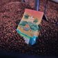 image of coffee bag in roaster bed full of beans