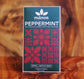 Image of peppermint bar in dark green package with red Hawaiian quilt pattern