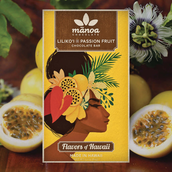 Image of Lilikoi passion fruit bar, in bright yellow packaging, sitting among sliced passion fruits