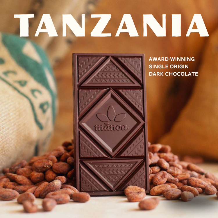 award winning single origin dark chocolate bar from Tanzania with cocoa beans on the background