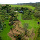 Image of drone shot of honolii cacao farm with groomed fields and trees