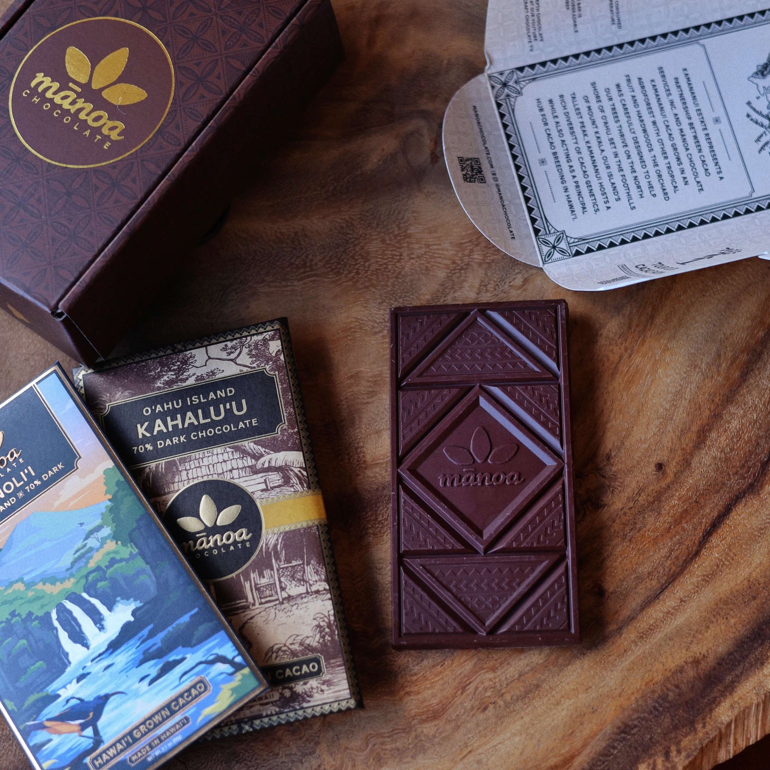 image of Manoa chocolate bars on a wooden surface
