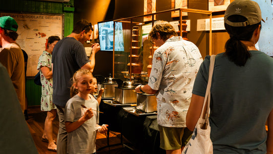 Image of factory tour guests enjoying the chocolate fountains
