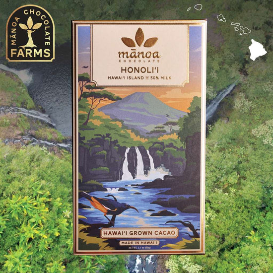 Image of honolii milk chocolate bar package placed over a waterfall background. Manoa Chocolate Farms logo in top left corner and Hawaiian islands chain in top right