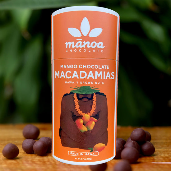 Image of brightly-colored, orange tube that says Mango Chocolate Macadamias. Made in Hawaii with Hawaii grown nuts
