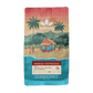 Image of a bag of Mānoa Coffee Roasters Mānoa Espresso coffee, featuring a tropical beach illustration with palm trees, a small hut, and a turquoise and coral color scheme on a white background.