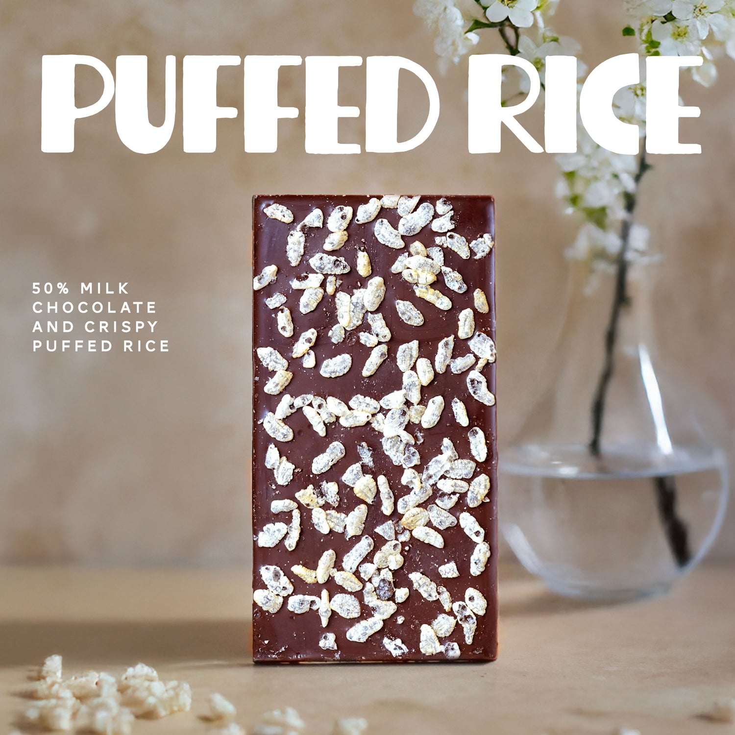 Chocolate bar with puffed rice on a wooden surface with a blurred background