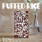 Chocolate bar with puffed rice on a wooden surface with a blurred background