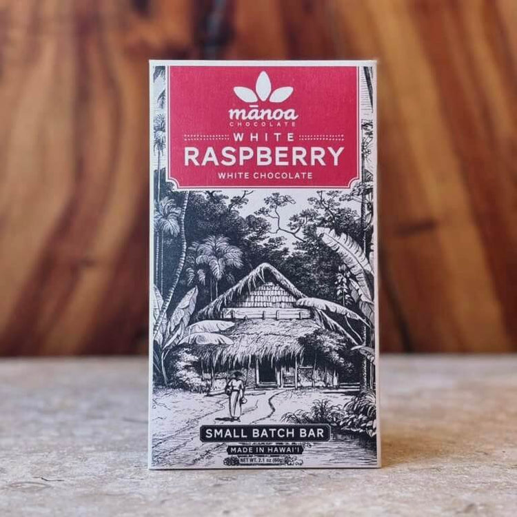 Manoa Chocolate White Raspberry white chocolate bar packaging on a wooden surface