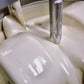 Image of liquid white chocolate in a stone grinder