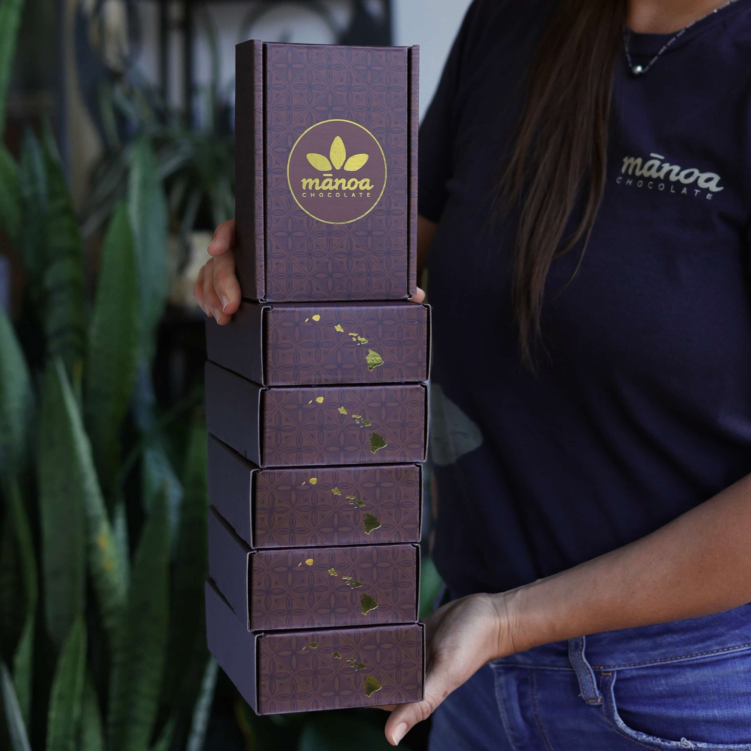 Woman holding 6 boxes of chocolate