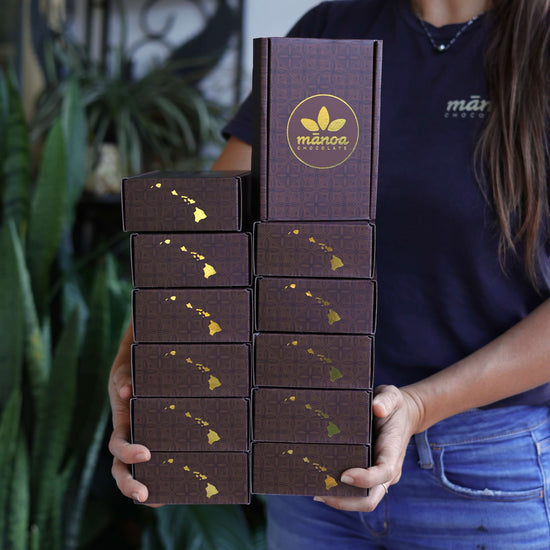 Image of woman holding 12 boxes of chocolate
