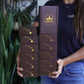 Woman holding 12 boxes of chocolate