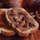 Toast with pecan almond butter, topped with roasted nuts