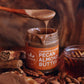 Spoon dripping with pecan almond butter