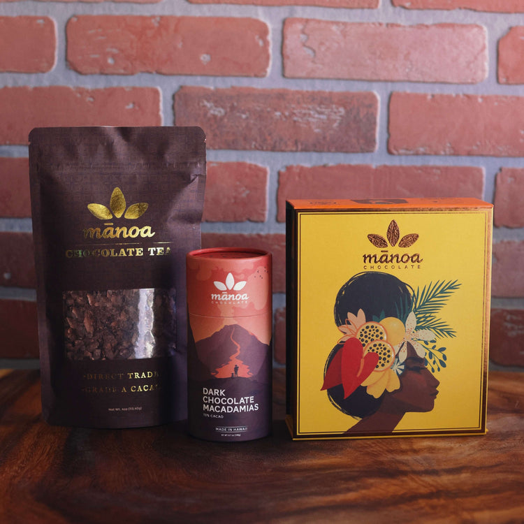 Image of 8oz pouch of chocolate tea, tube of dark chocolate macadamias, and a Flavors of Hawaii chocolate gift box