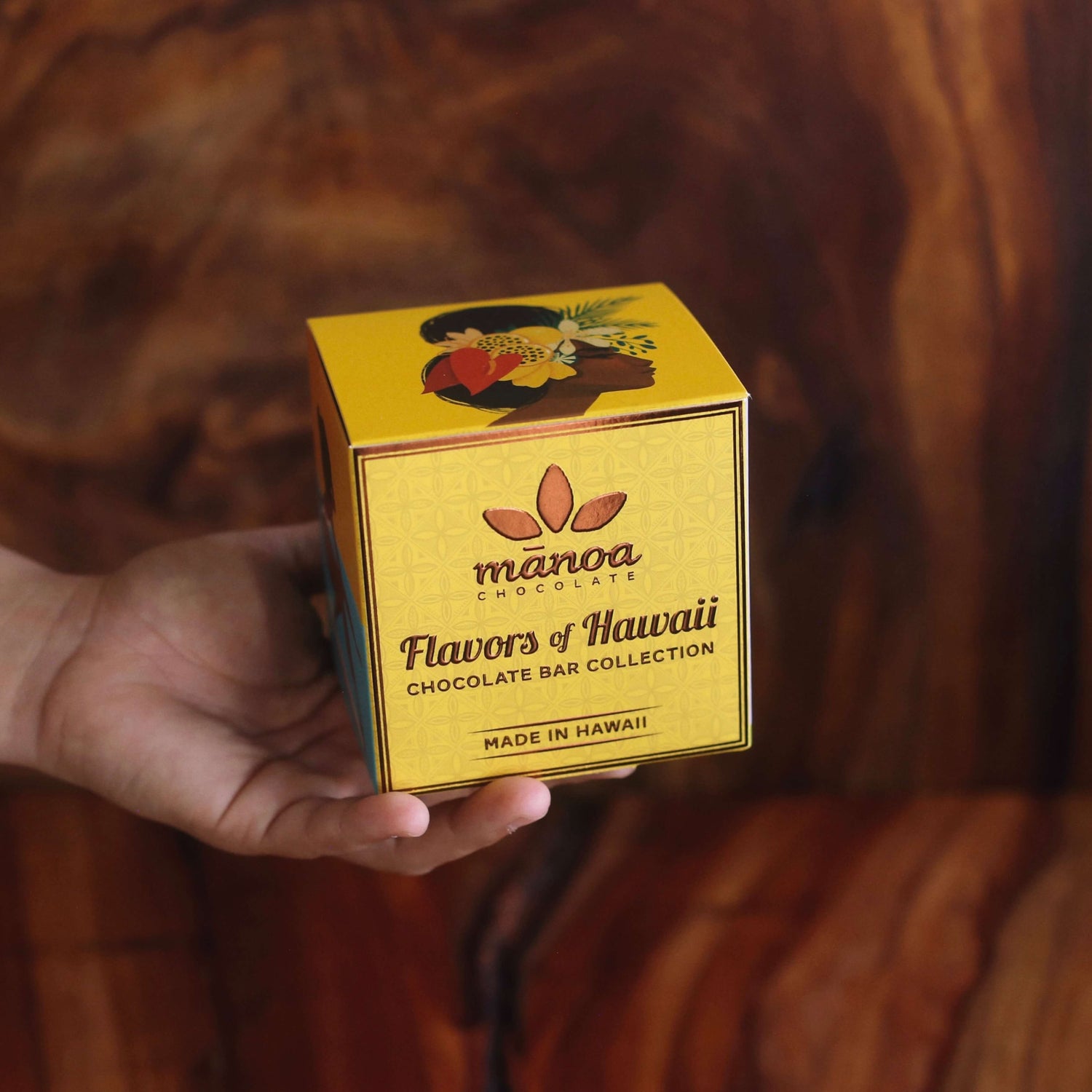Image of yellow cube-shaped box with "Flavors of Hawaii Chocolate Bar Collection" on the front