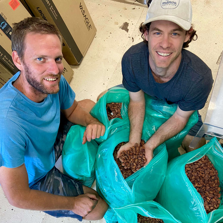 Employees showing off cacao beans