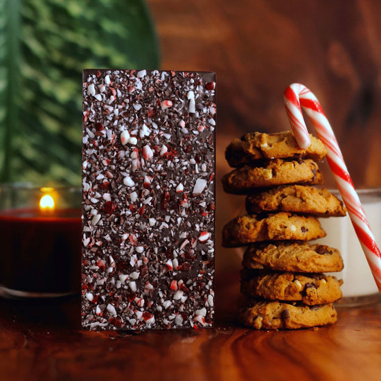 Image of dark chocolate bar with crushed candy canes and cacao nibs on the back