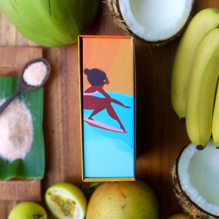 Image of the side of the brightly-colored gift box, with surfing girl artwork